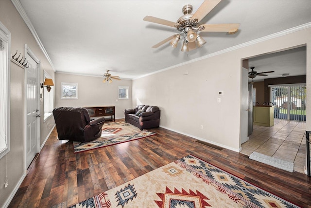 living area with wood finished floors, baseboards, and plenty of natural light