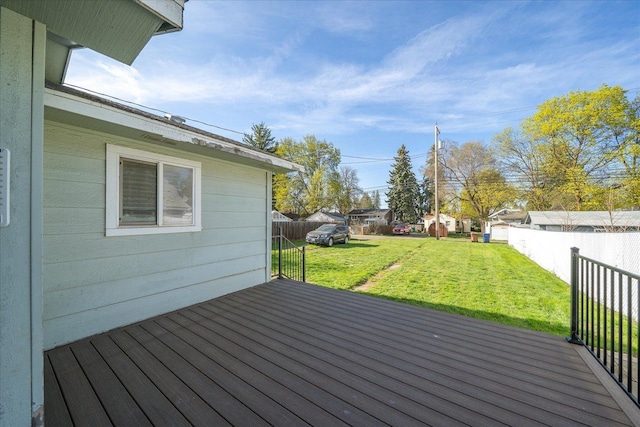 wooden deck with fence and a lawn