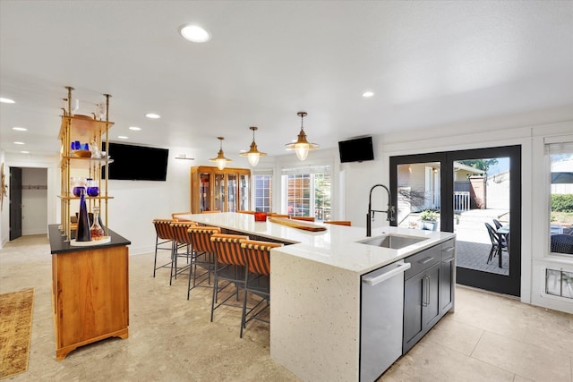 kitchen featuring hanging light fixtures, a sink, recessed lighting, a large island with sink, and stainless steel dishwasher