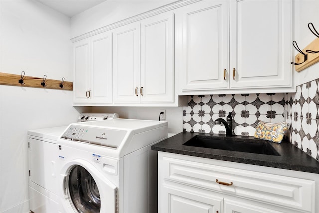 laundry area featuring a sink, washer and clothes dryer, and cabinet space