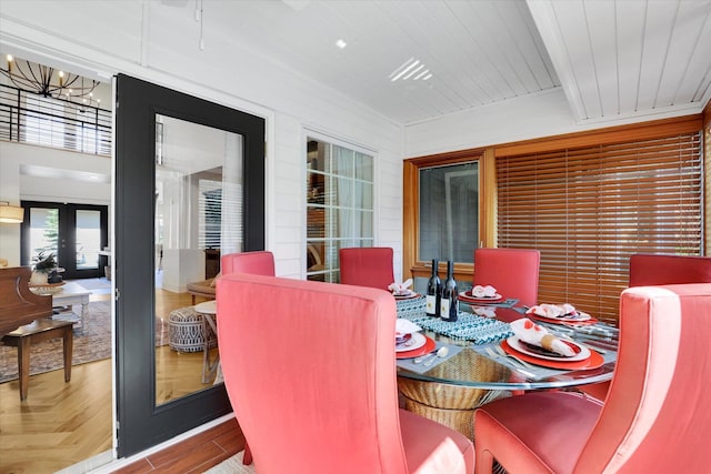 dining area featuring french doors, wooden ceiling, and wood finished floors