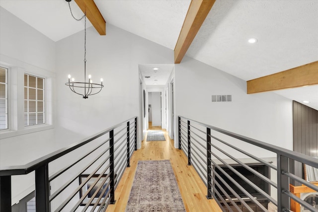 corridor with visible vents, recessed lighting, an inviting chandelier, and light wood-style floors