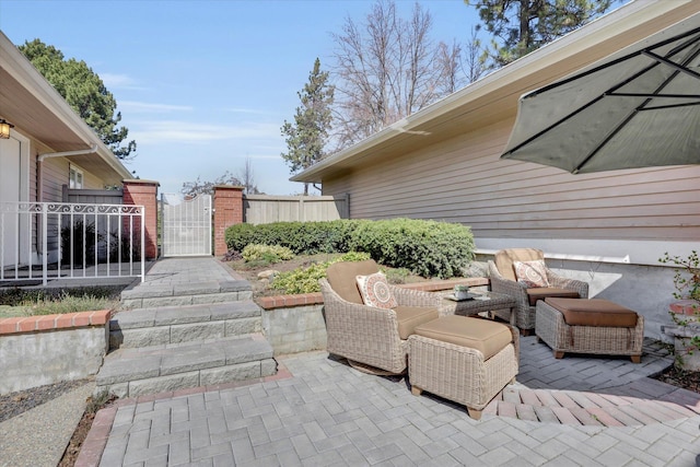view of patio / terrace featuring fence and a gate