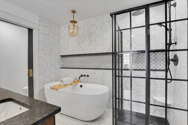bathroom featuring vanity, tile patterned flooring, a freestanding bath, tile walls, and a tile shower