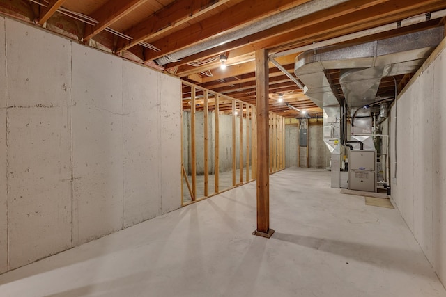 unfinished basement with heating unit and electric panel