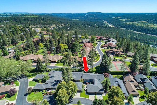 bird's eye view featuring a forest view and a residential view