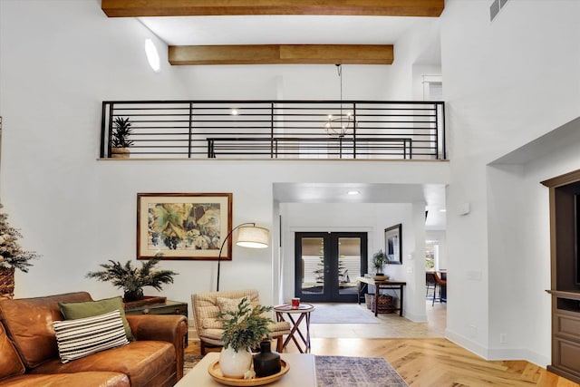 living area with baseboards, visible vents, a high ceiling, and beamed ceiling