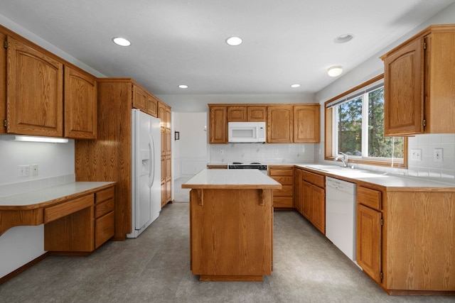 kitchen featuring tasteful backsplash, a center island, a sink, white appliances, and recessed lighting