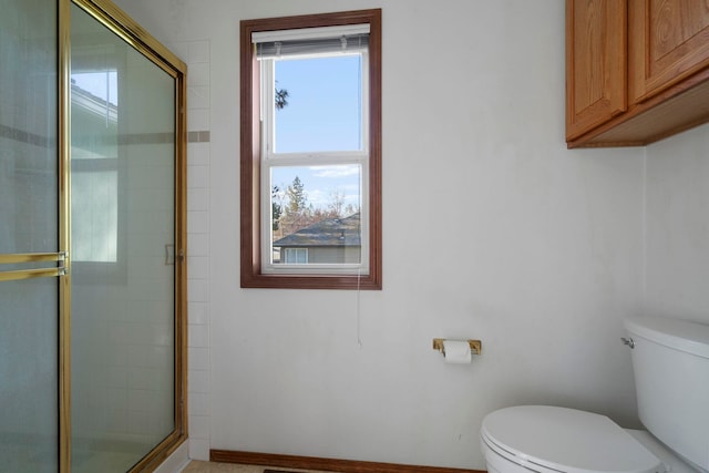 full bath featuring a shower stall and toilet