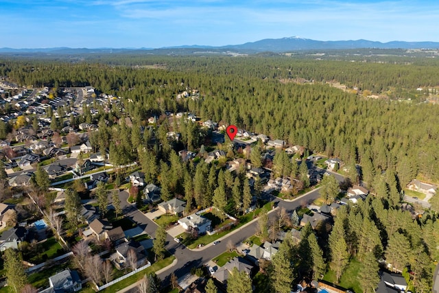 aerial view with a mountain view, a forest view, and a residential view