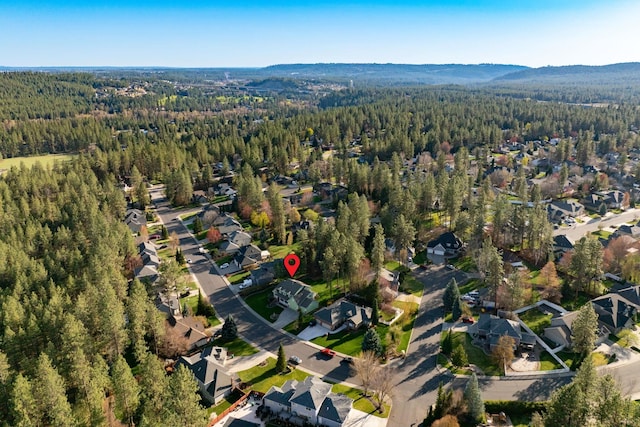 birds eye view of property with a forest view and a residential view