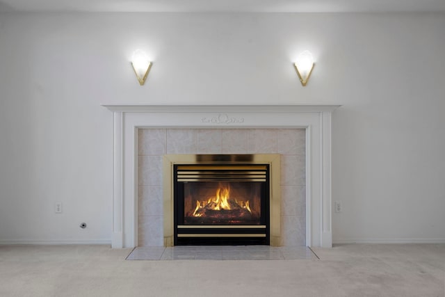 details featuring a tile fireplace, baseboards, and carpet
