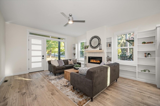 3022 S Manito Blvd, Spokane, WA 99203 - living room with light wood finished floors, a glass covered fireplace, ceiling fan, and a healthy amount of sunlight