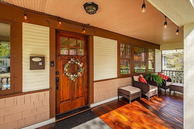 view of exterior entry featuring a porch