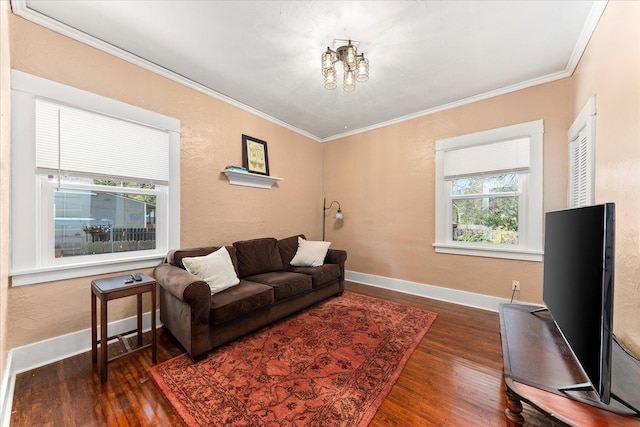 living area featuring wood finished floors, a notable chandelier, and ornamental molding
