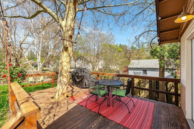 wooden deck featuring outdoor dining space