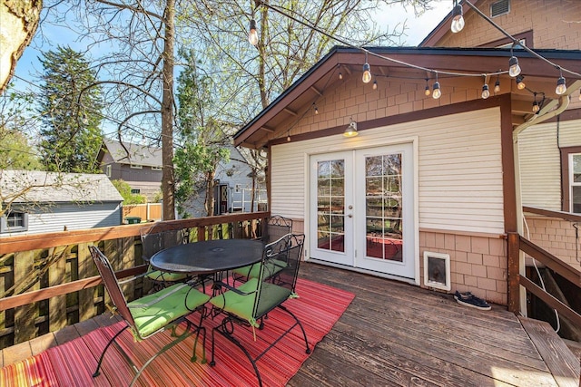 deck with outdoor dining space and french doors