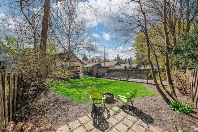 view of yard featuring a fenced backyard, an outdoor fire pit, and a patio