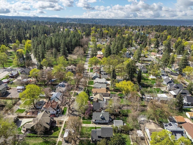 birds eye view of property featuring a residential view and a wooded view