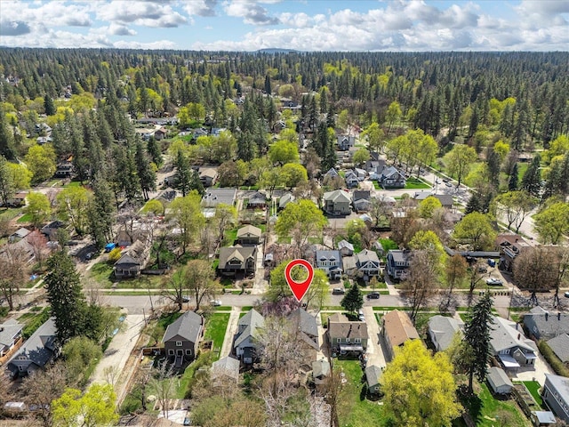 drone / aerial view with a residential view and a forest view