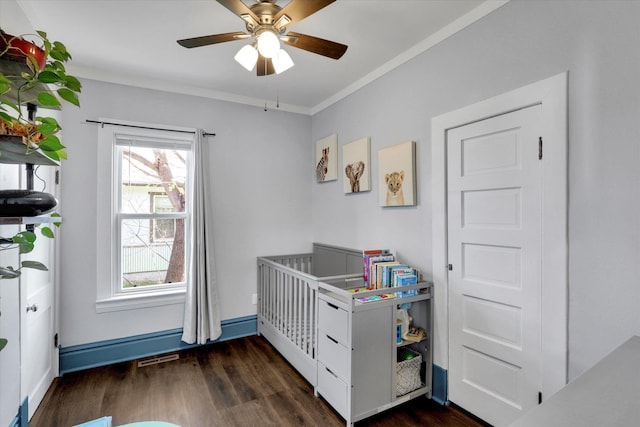 1303 E Rich Ave, Spokane, WA 99207 - bedroom featuring dark wood finished floors, ornamental molding, multiple windows, and ceiling fan