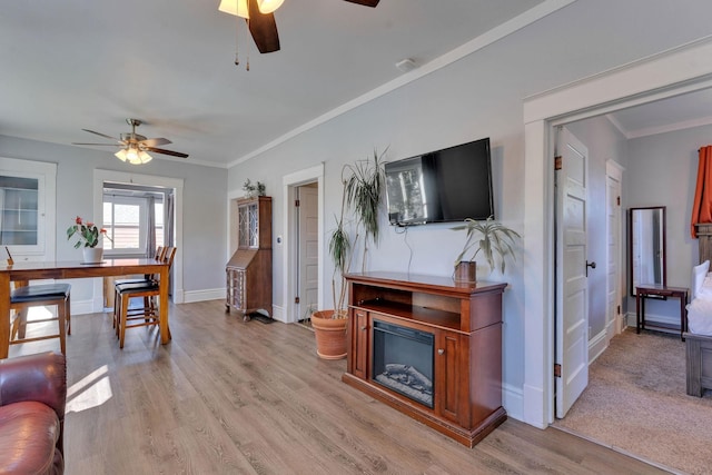 1303 E Rich Ave, Spokane, WA 99207 - living room with light wood finished floors, a ceiling fan, baseboards, and crown molding