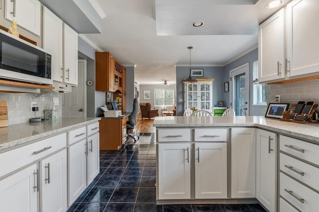 6901 W Depot Springs Rd, Cheney, WA 99004 - kitchen featuring stainless steel microwave, ornamental molding, and white cabinetry