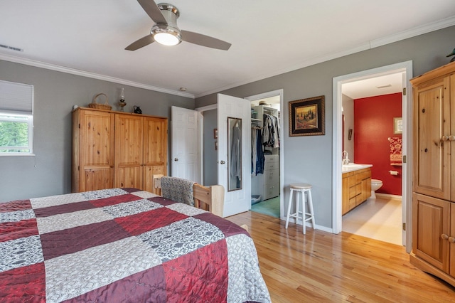 6901 W Depot Springs Rd, Cheney, WA 99004 - bedroom featuring visible vents, ornamental molding, a walk in closet, light wood-type flooring, and ensuite bathroom