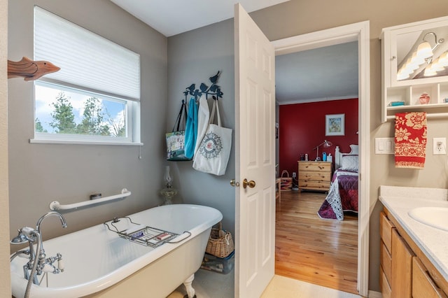 6901 W Depot Springs Rd, Cheney, WA 99004 - ensuite bathroom featuring a freestanding tub, vanity, wood finished floors, and ensuite bathroom