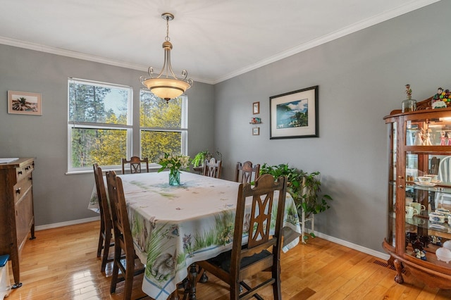 6901 W Depot Springs Rd, Cheney, WA 99004 - dining space featuring visible vents, baseboards, light wood-style floors, and ornamental molding