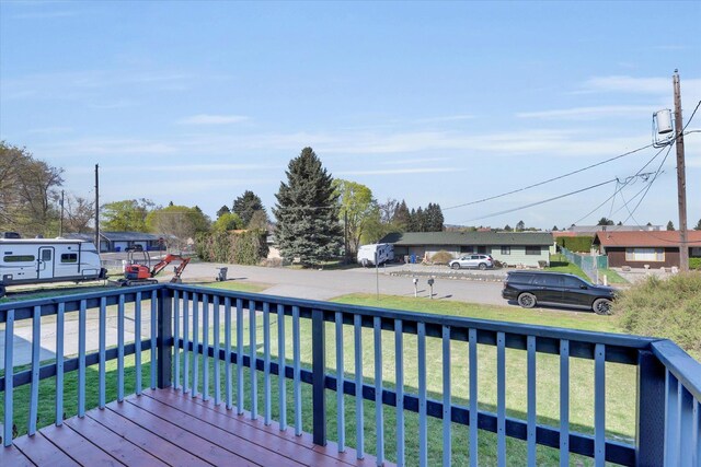 wooden deck with a lawn
