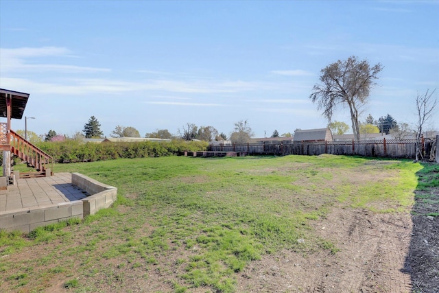 view of yard featuring stairway and fence