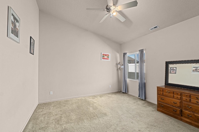 12827 W 3rd Ave, Airway Heights, WA 99001 - unfurnished bedroom with light carpet, vaulted ceiling, ceiling fan, and a textured ceiling