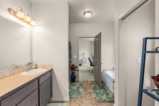 12827 W 3rd Ave, Airway Heights, WA 99001 - bathroom with vanity, a garden tub, and stone finish floors