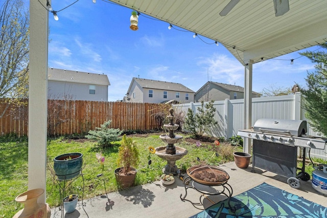 12827 W 3rd Ave, Airway Heights, WA 99001 - fenced backyard with a patio, a grill, a ceiling fan, a residential view, and an outdoor fire pit