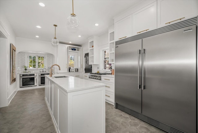530 E 11th Ave, Spokane, WA 99202 - kitchen featuring decorative backsplash, recessed lighting, white cabinetry, a sink, and stainless steel appliances