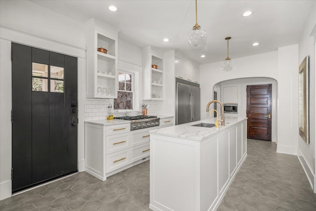 530 E 11th Ave, Spokane, WA 99202 - kitchen with arched walkways, tasteful backsplash, a sink, built in appliances, and recessed lighting