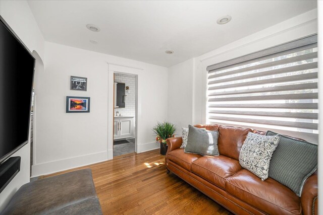 530 E 11th Ave, Spokane, WA 99202 - living room with baseboards, arched walkways, wood finished floors, and recessed lighting