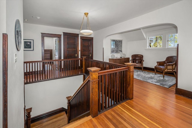 530 E 11th Ave, Spokane, WA 99202 - staircase with baseboards, arched walkways, and wood finished floors