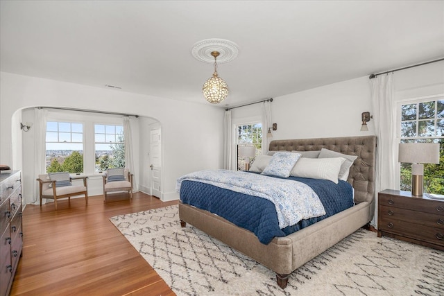 530 E 11th Ave, Spokane, WA 99202 - bedroom featuring arched walkways, visible vents, multiple windows, and wood finished floors