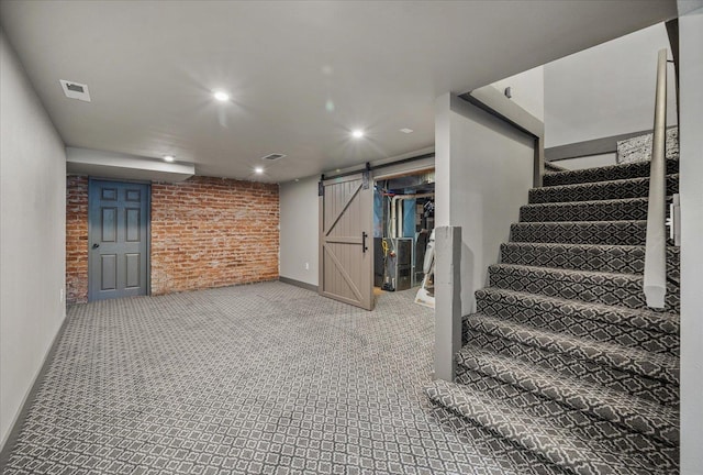 530 E 11th Ave, Spokane, WA 99202 - finished below grade area featuring visible vents, baseboards, stairway, a barn door, and carpet
