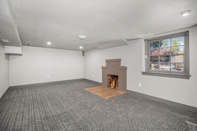 530 E 11th Ave, Spokane, WA 99202 - basement with carpet floors, visible vents, a fireplace, baseboards, and recessed lighting