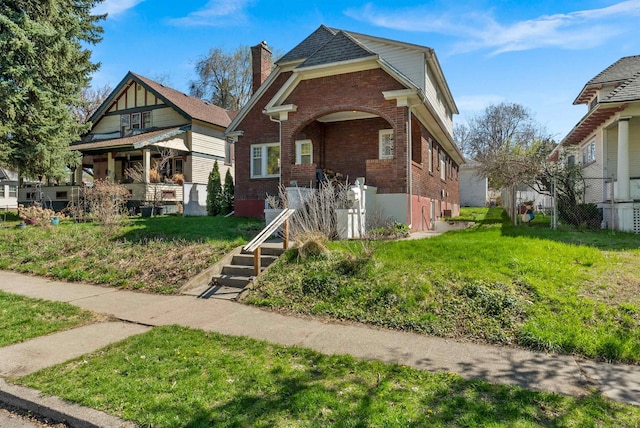 1607 W 11th Ave, Spokane, WA 99204 - view of front of house with brick siding, a front lawn, a chimney, and a porch