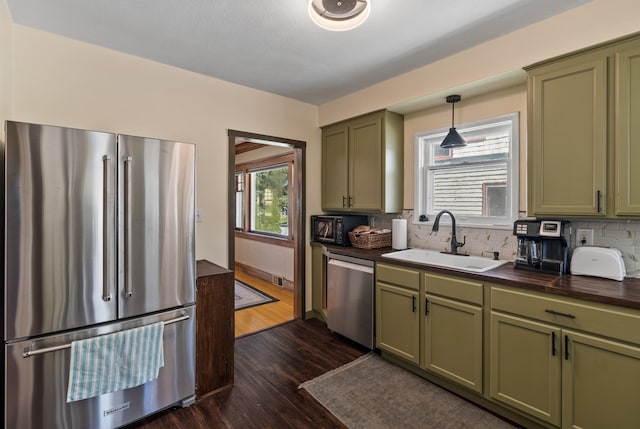 1607 W 11th Ave, Spokane, WA 99204 - kitchen featuring green cabinetry, appliances with stainless steel finishes, and dark wood-type flooring