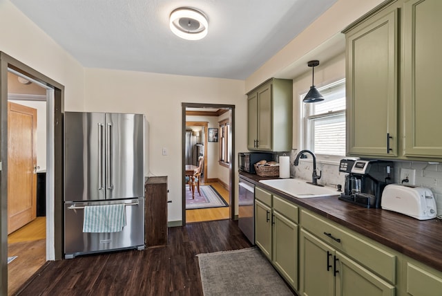 1607 W 11th Ave, Spokane, WA 99204 - kitchen featuring green cabinets, appliances with stainless steel finishes, and dark wood-style flooring