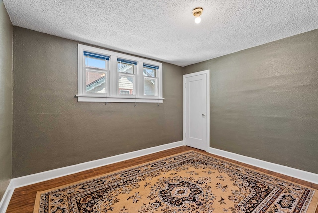1607 W 11th Ave, Spokane, WA 99204 - unfurnished room with wood finished floors and a textured ceiling