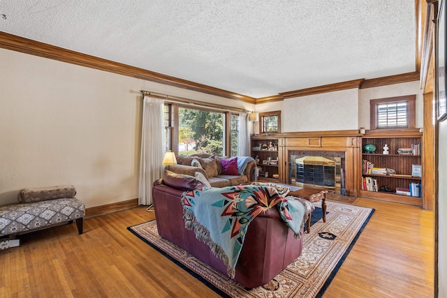 1607 W 11th Ave, Spokane, WA 99204 - living room featuring crown molding, a textured ceiling, wood finished floors, and a premium fireplace