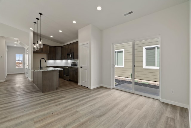 kitchen featuring stainless steel appliances, visible vents, recessed lighting, dark brown cabinetry, and light wood-style floors