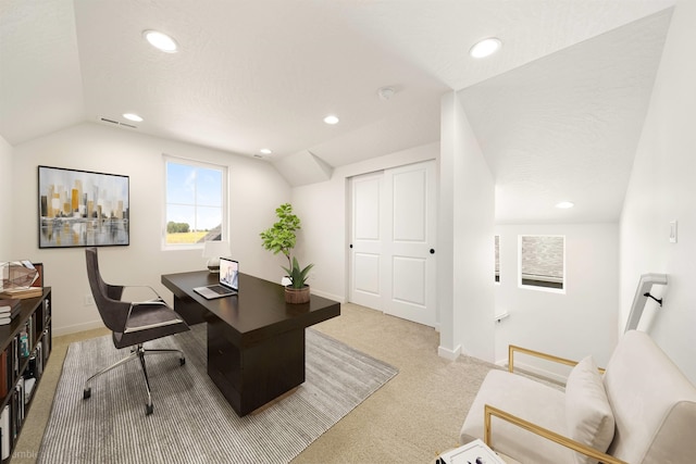 office featuring vaulted ceiling, light carpet, baseboards, visible vents, and recessed lighting