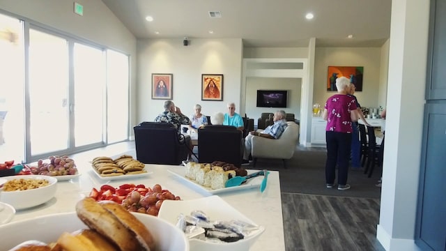 living area featuring dark wood-type flooring, plenty of natural light, visible vents, and recessed lighting